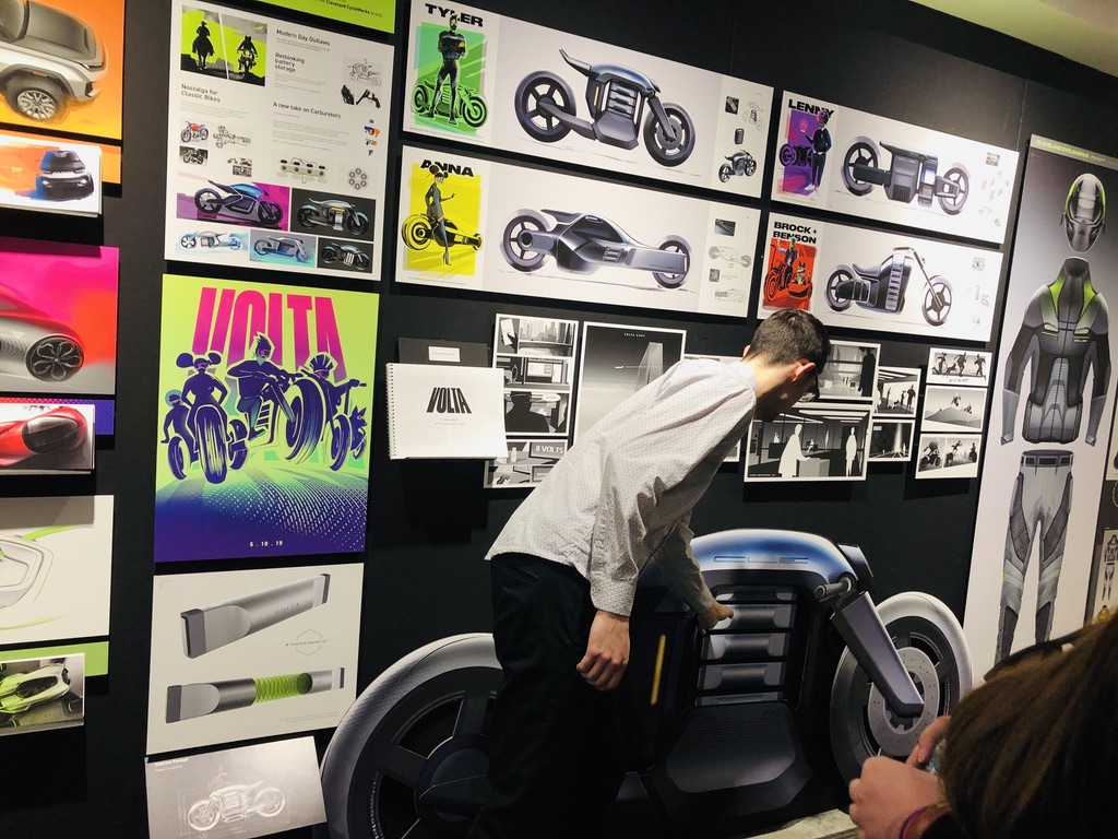 VOLTA electric motorcycle scale model with thesis wall